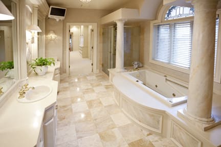 A bathroom with two sinks and a large tub.