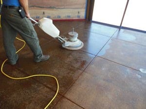 A man is cleaning the floor with a machine.