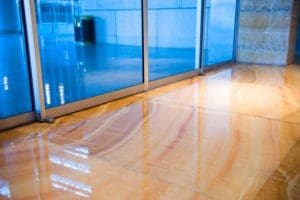 A large room with glass walls and wood floors.
