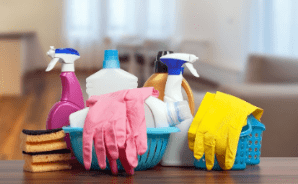 A table with cleaning supplies and gloves on it.