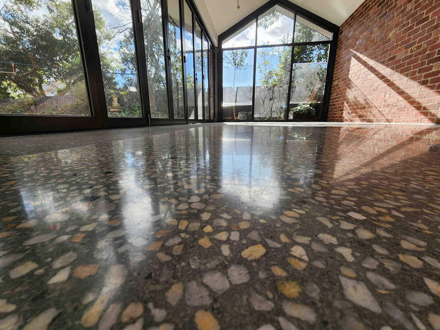 AggregateConcreteFloor A view of a room with a floor that has been polished.