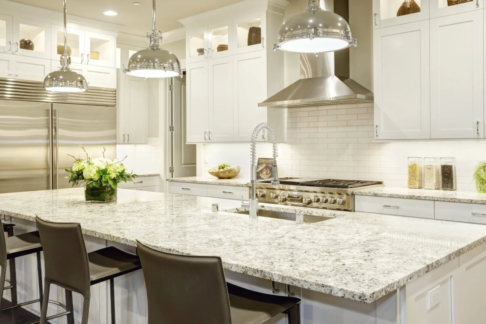 White,Kitchen,Design,Features,Large,Bar,Style,Kitchen,Island,With A kitchen with white cabinets and granite counter tops.